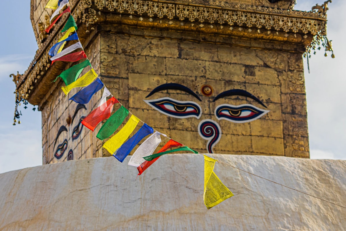 Buddha's wisdom eyes painted on the golden spire of a Swayambhunath stupa