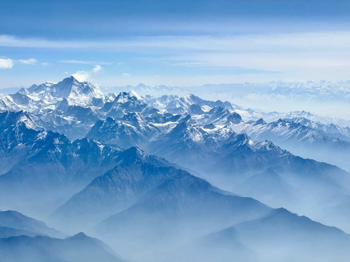 Panoramic view of snow-covered Himalayan peaks from a mountain flight over Nepal.