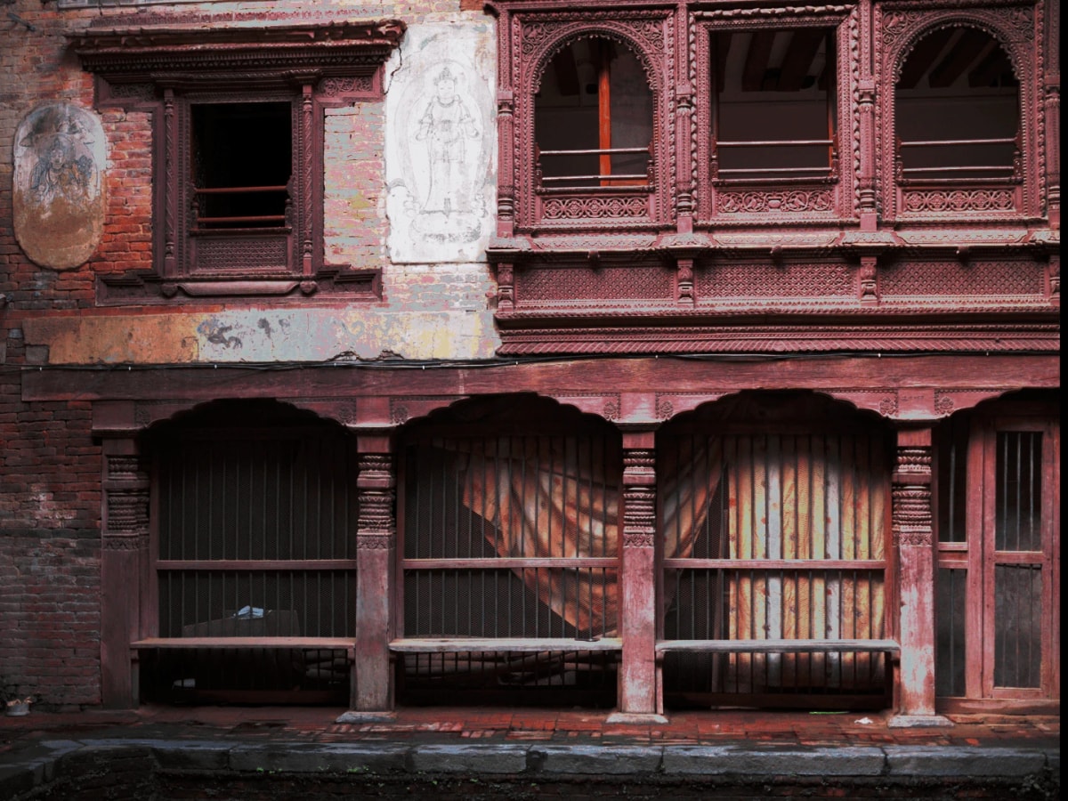 A wooden face of a home inside Patan's alleys