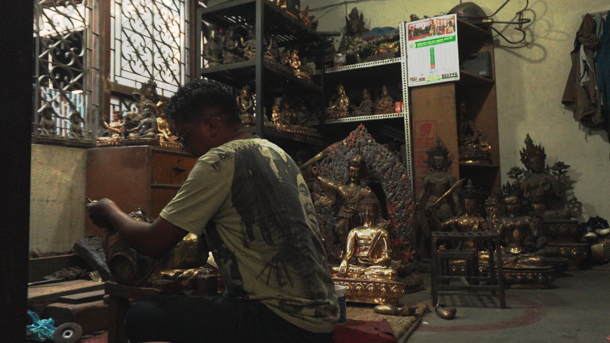 An Artist in his workshop making metal statues